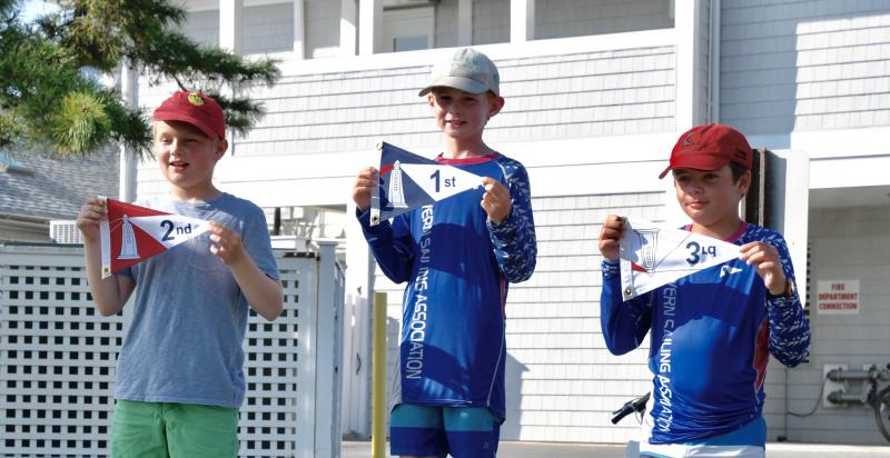 Severn Sailing Association team members take top honors in the Optimist white fleet. The winners are (l-r) Thomas Wood, second; Daniel Skutch Tyson, first; and Dylan Cook, third.